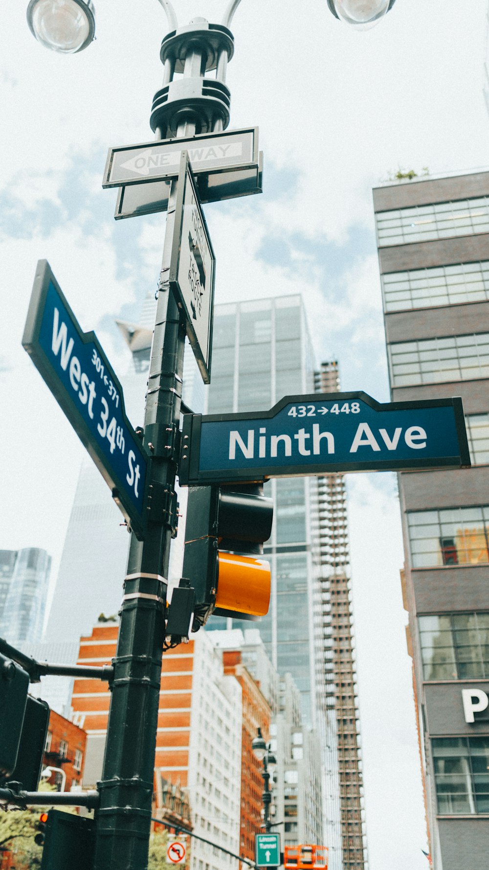 a street sign on a pole in the middle of a city