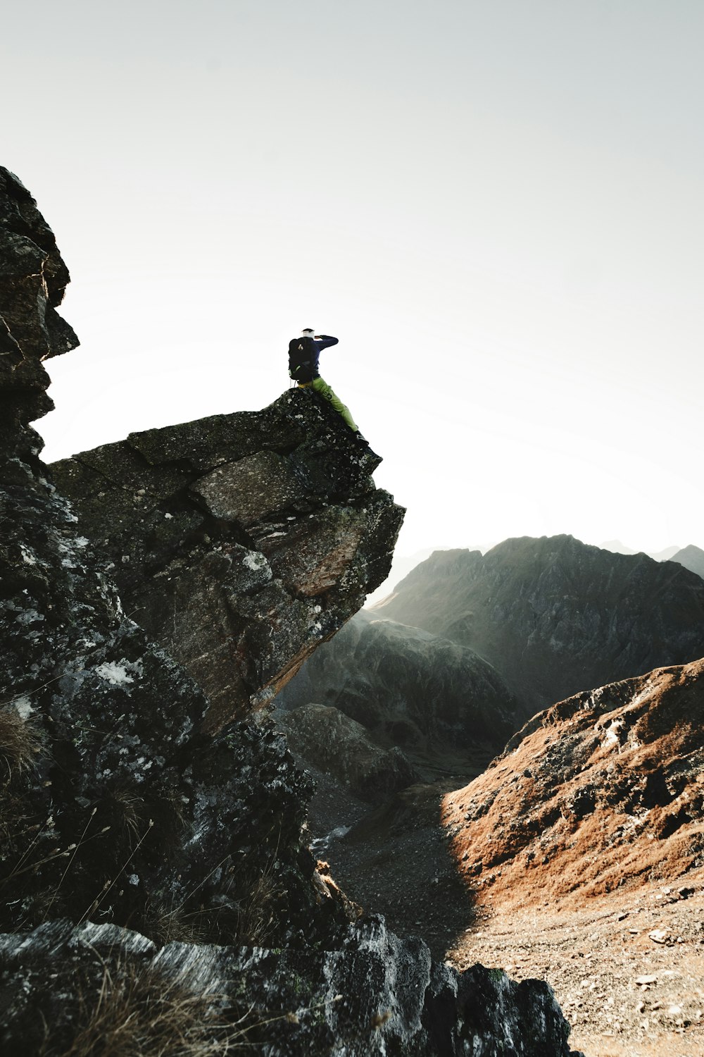 a person standing on top of a large rock