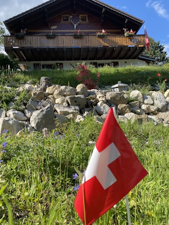 a red and white flag in front of a building