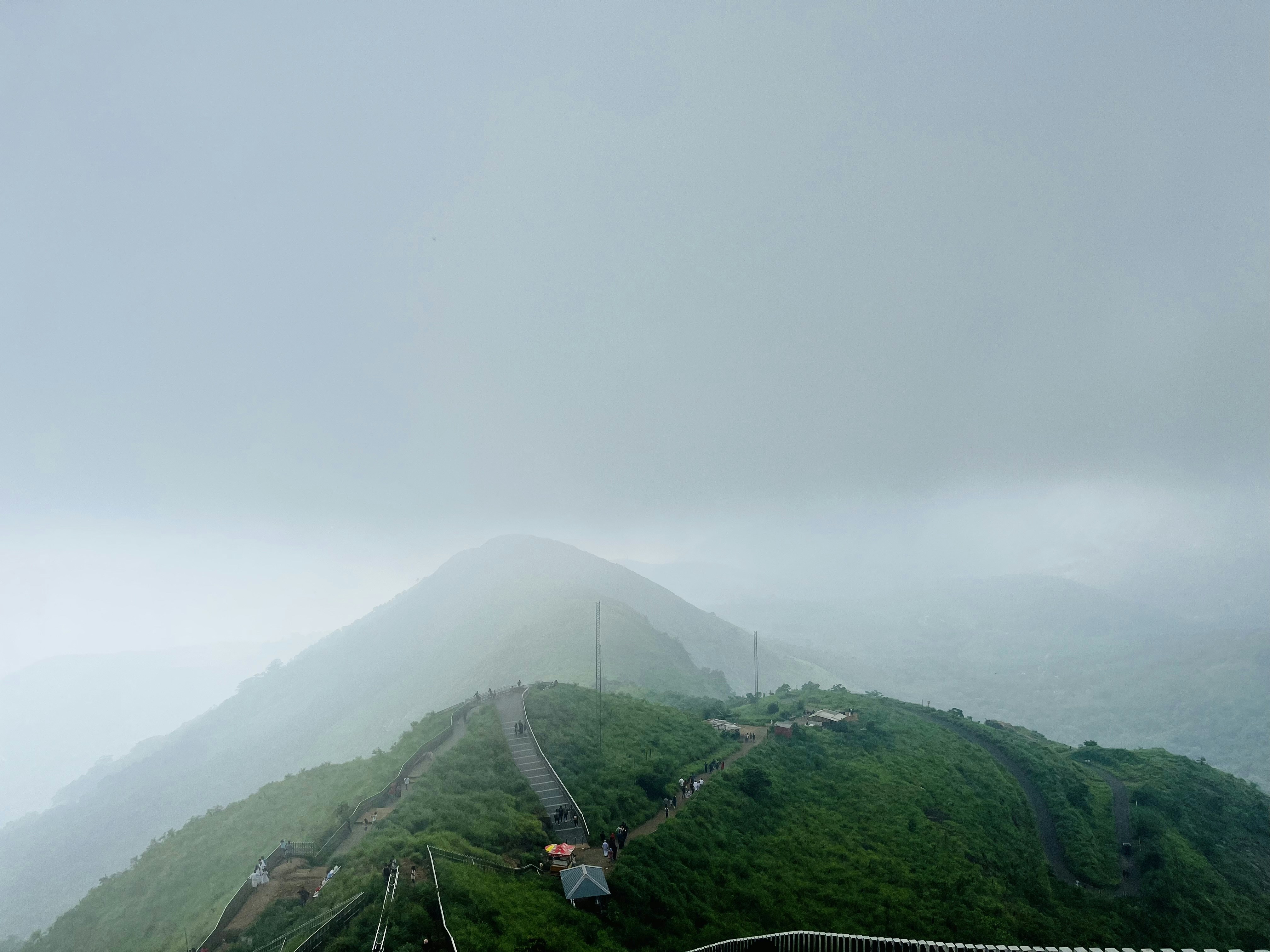 a view of the top of a mountain on a cloudy day