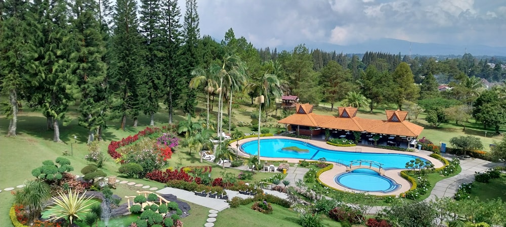 a bird's eye view of a pool surrounded by trees