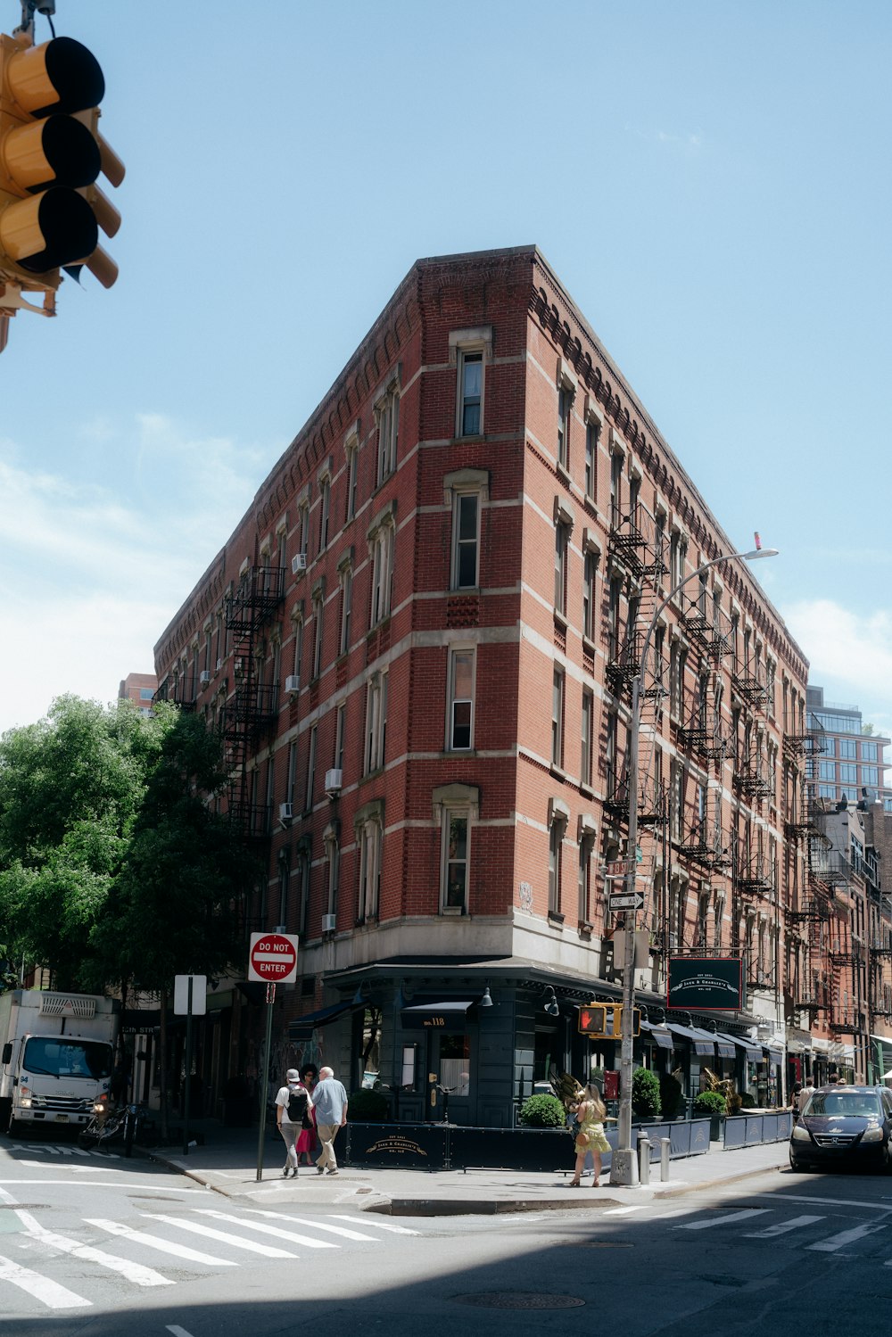 a tall brick building sitting on the corner of a street