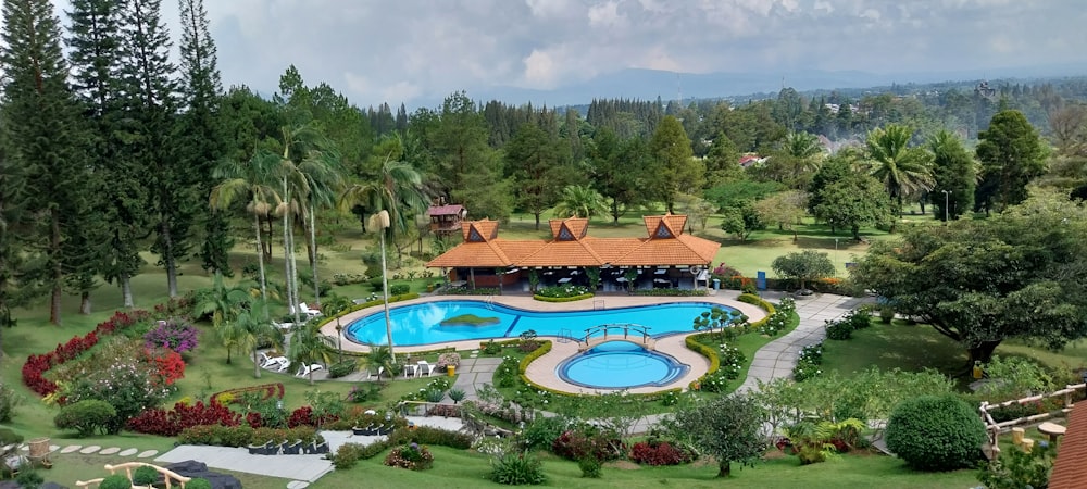 an aerial view of a resort with a swimming pool