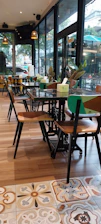 Cozy interior of eco-café urbano with warm wooden tones and green plants reflecting the brand colors.