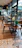 Chic café interior showcasing rustic wood pattern PVC flooring under elegant lighting and minimalist furniture.