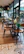 Chic café interior showcasing rustic wood pattern PVC flooring under elegant lighting and minimalist furniture.
