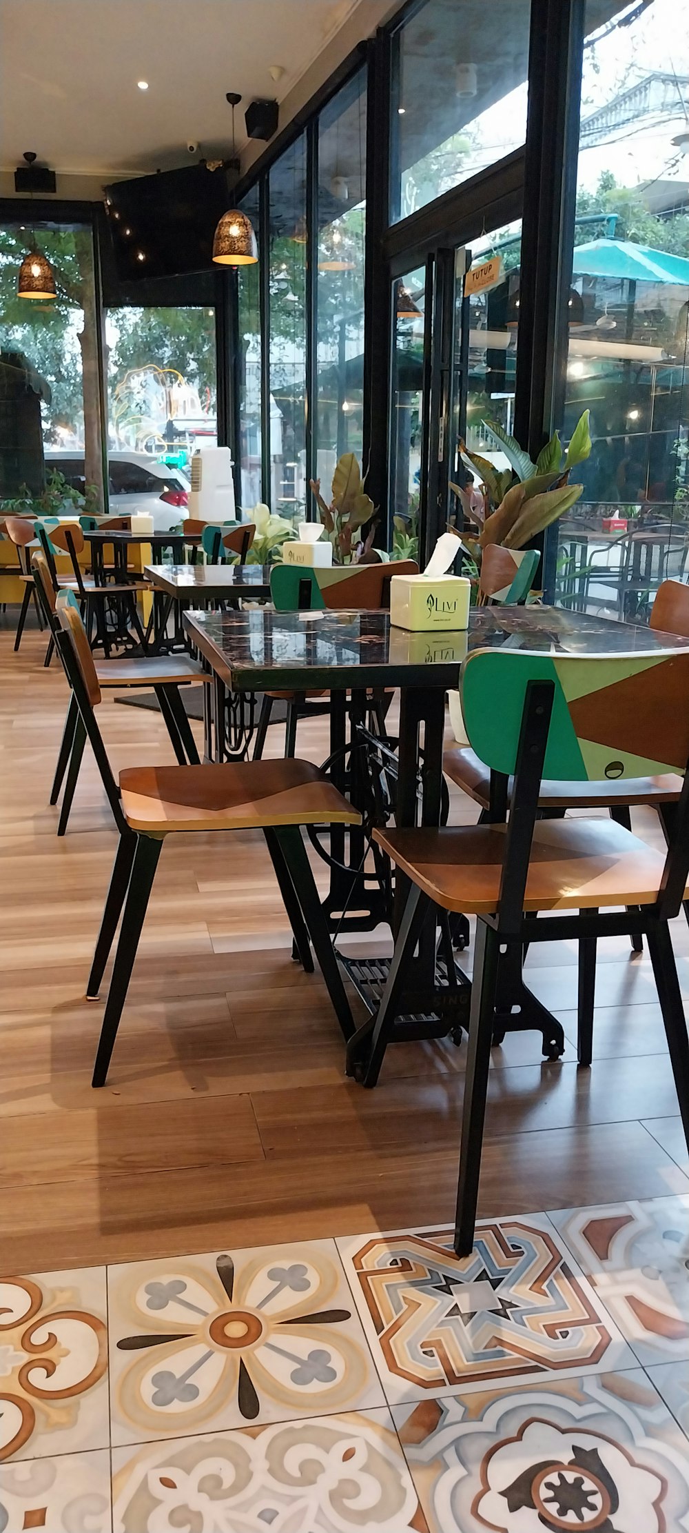 a restaurant with tables and chairs in front of a large window