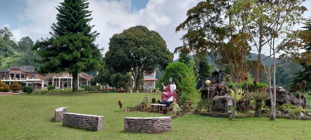 a woman sitting on a bench in a park