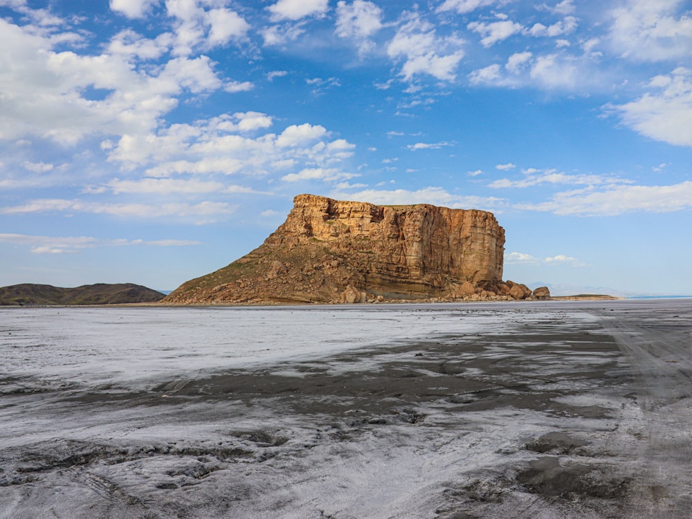 a large rock outcropping in the middle of a desert