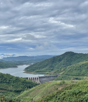 a large body of water surrounded by lush green hills