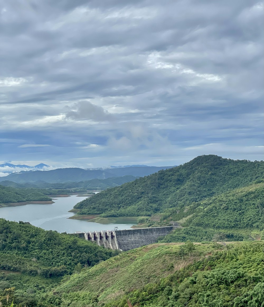 a large body of water surrounded by lush green hills