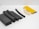 Various pieces of foam and rubber insulation materials are neatly arranged on a white surface. The objects vary in shape from rectangular blocks to curved and tubular forms. They display a combination of colors including black, white, and yellow.