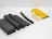 Various pieces of foam and rubber insulation materials are neatly arranged on a white surface. The objects vary in shape from rectangular blocks to curved and tubular forms. They display a combination of colors including black, white, and yellow.