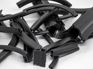 A collection of various industrial hoses displayed on a wooden surface.