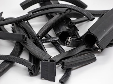 A collection of various industrial hoses displayed on a wooden surface.