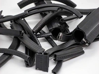Rubber profiles arranged neatly on a workbench, showcasing various shapes and sizes