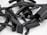 A collection of various black, cylindrical and rectangular rubber pieces with textured surfaces, some of which are partially open revealing metallic clips or inner components, arranged randomly on a flat, light-colored surface.