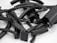 A collection of various black, cylindrical and rectangular rubber pieces with textured surfaces, some of which are partially open revealing metallic clips or inner components, arranged randomly on a flat, light-colored surface.