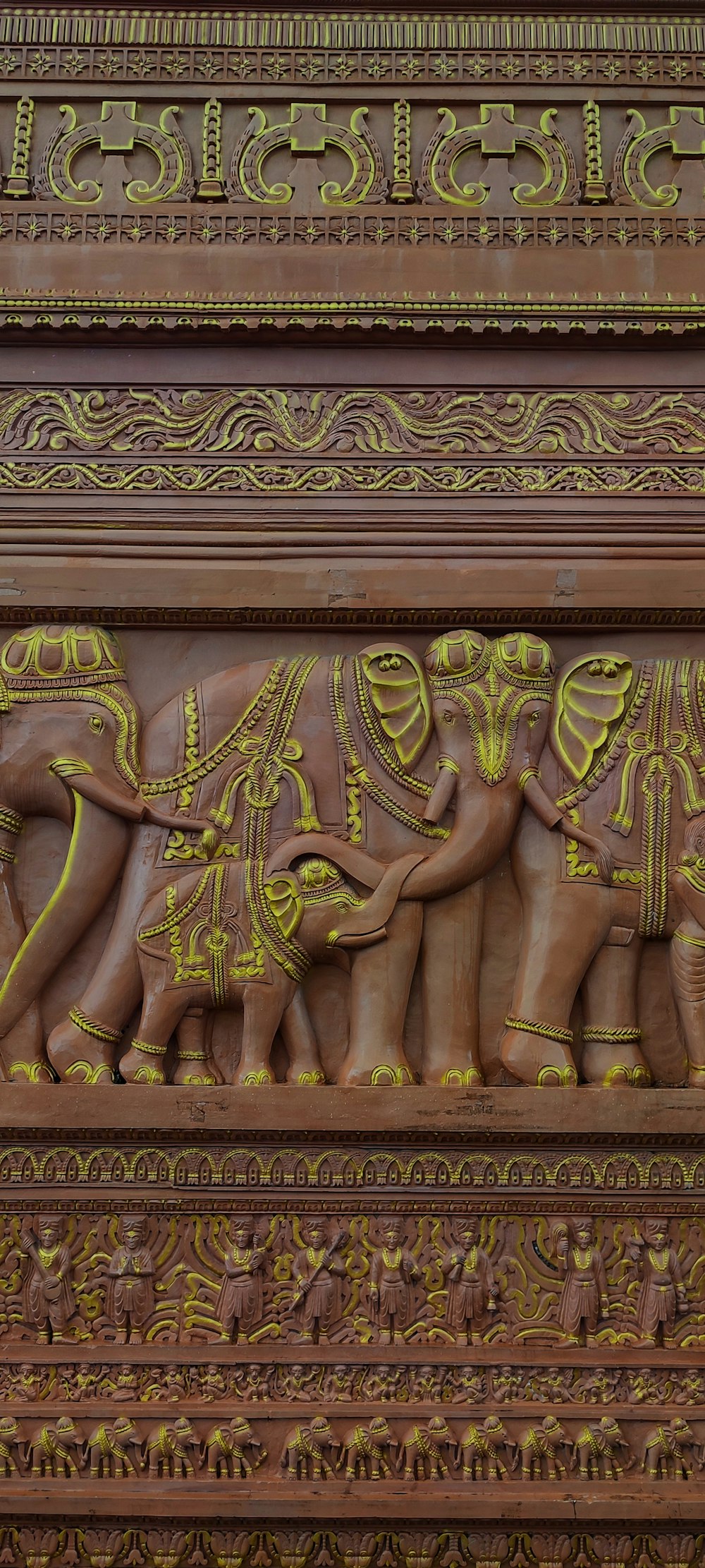 an intricately carved wooden carving of elephants