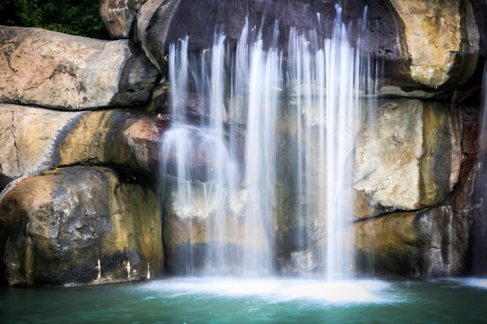 a large waterfall in the middle of a pool of water