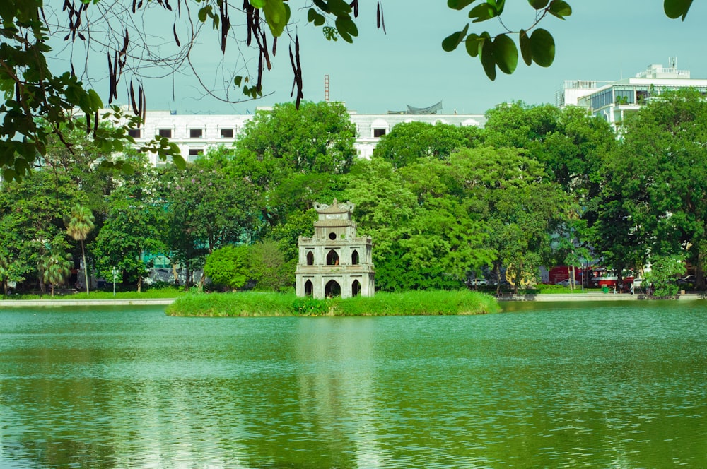 a lake with a clock tower in the middle of it