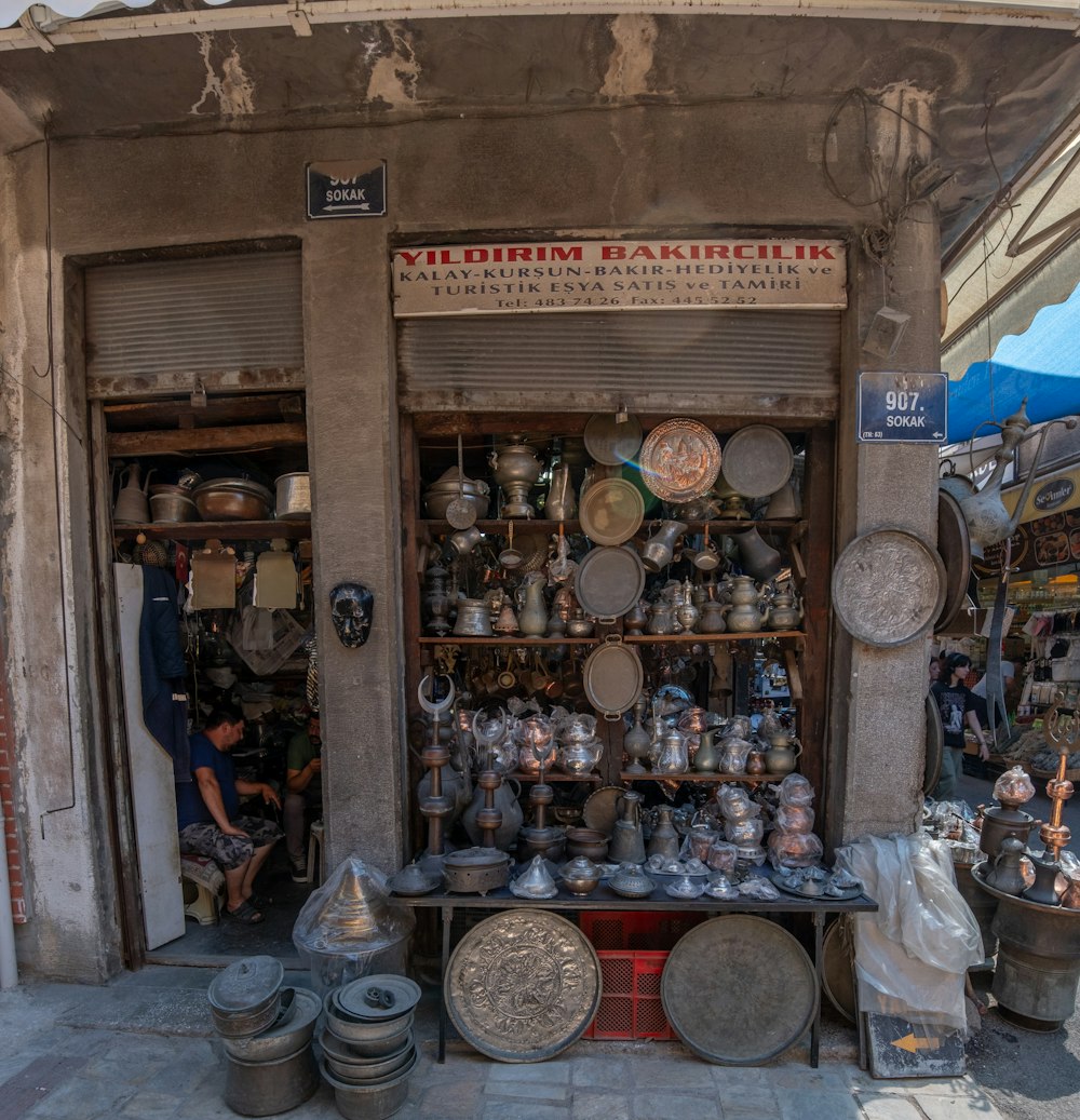a store front with pots and pans on display
