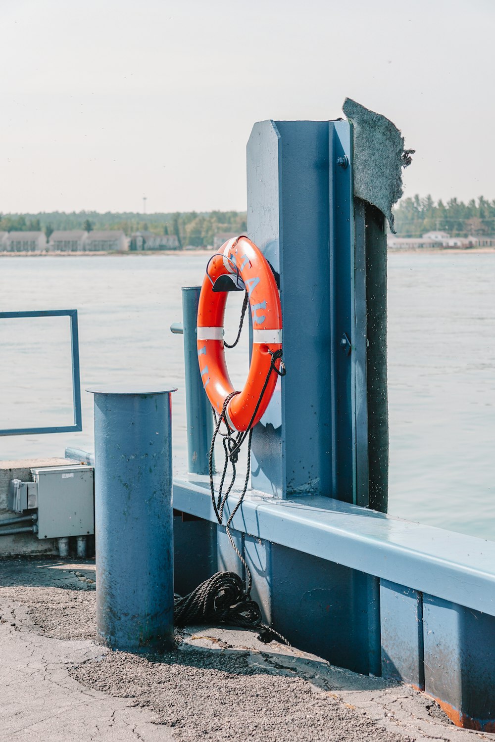 a life preserver on a dock next to the water