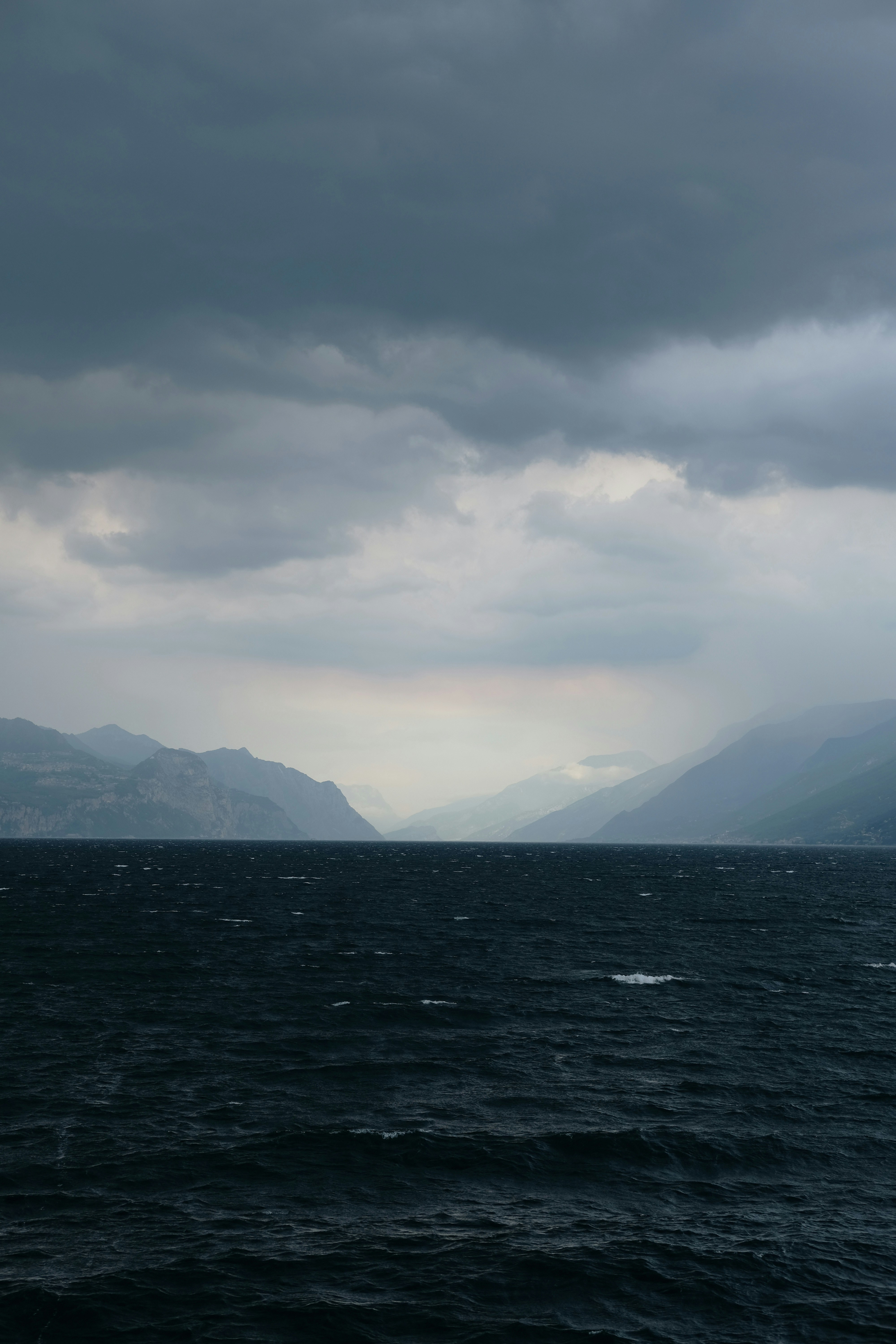 a large body of water under a cloudy sky
