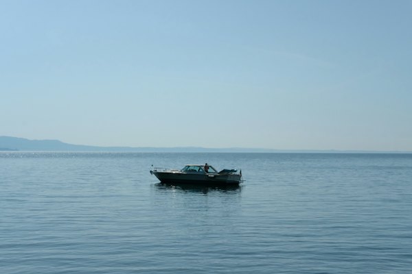 A small boat floating on top of a large body of water — Lake Garda, Italy