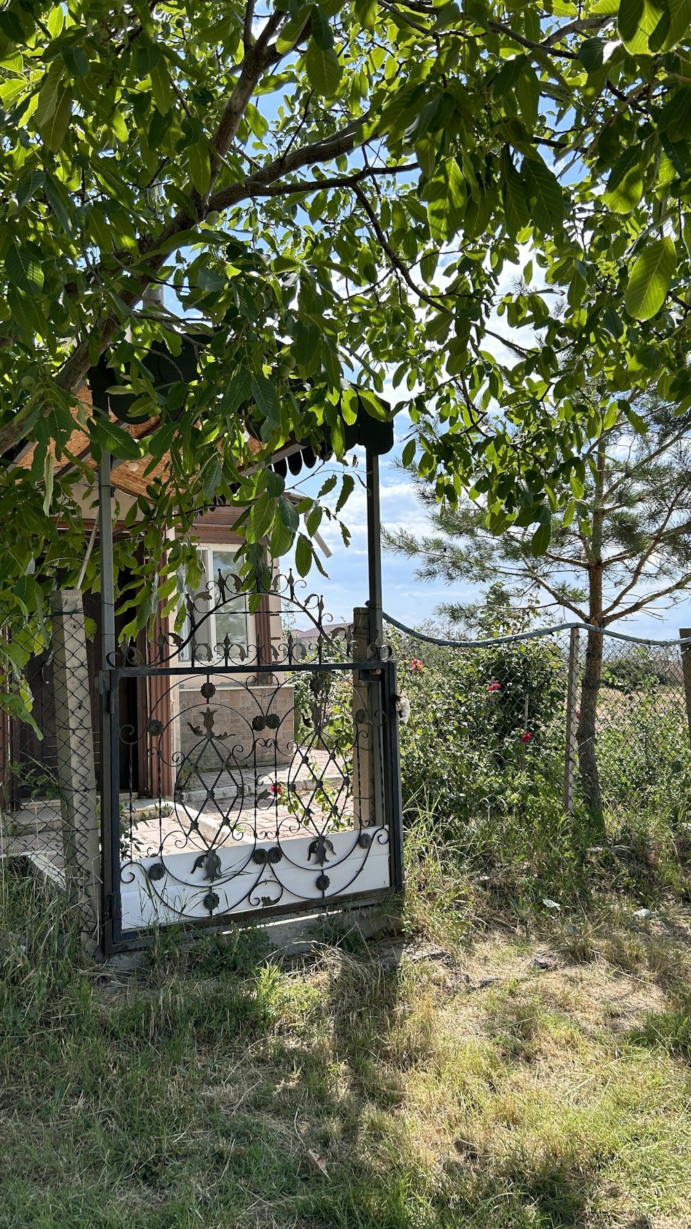 a gated in area with a house in the background