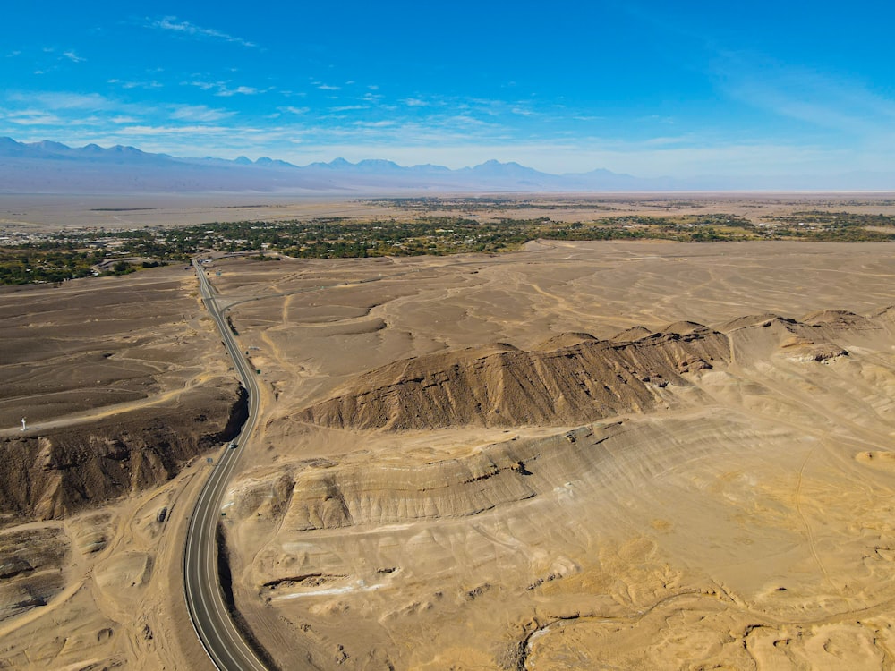 an aerial view of a dirt road in the desert