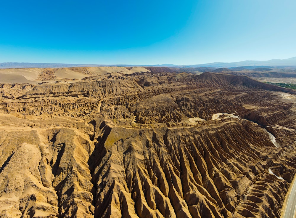 an aerial view of a desert landscape with mountains