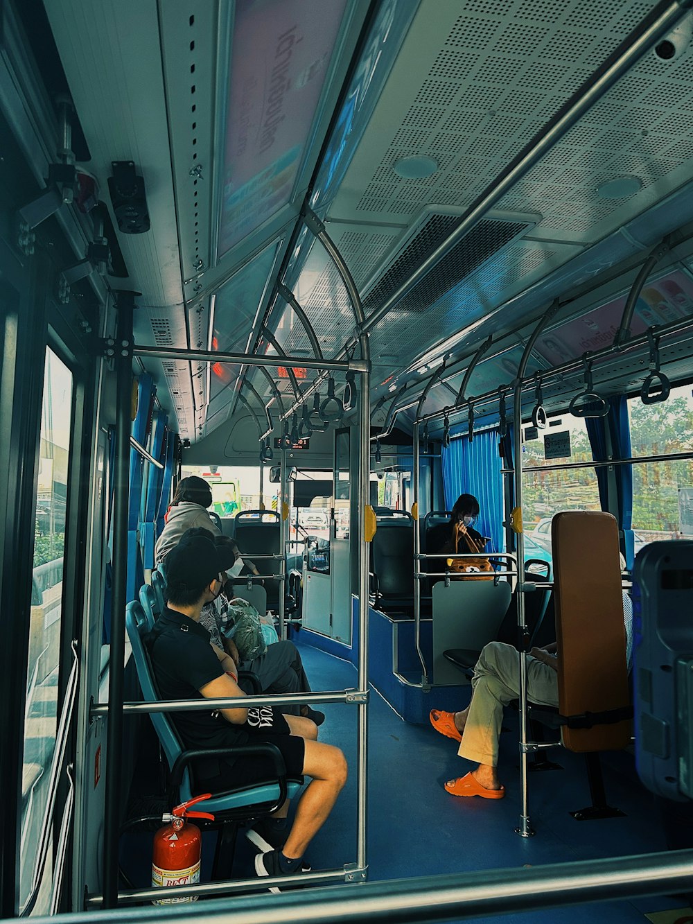 a man sitting on a bus looking out the window