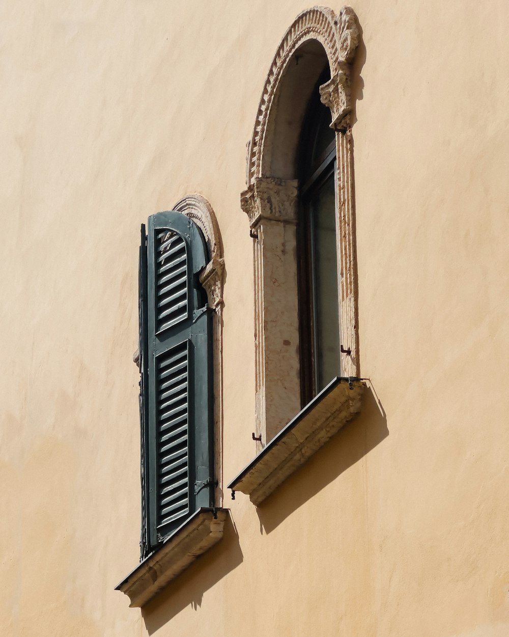 two windows on the side of a building