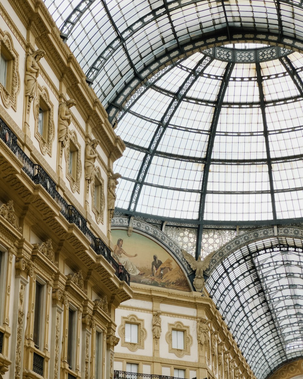 a large building with a glass ceiling and a clock