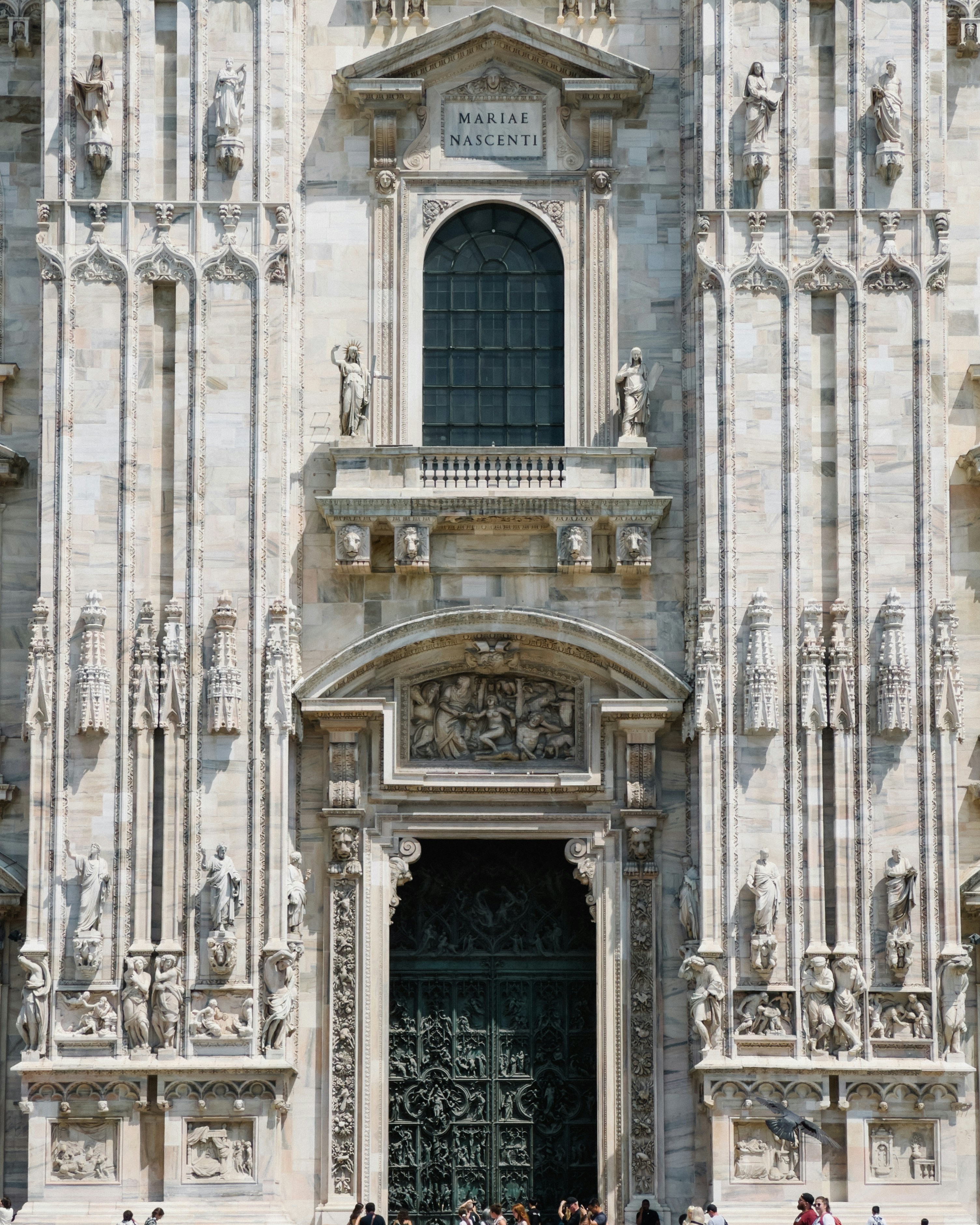 a group of people standing in front of a tall building