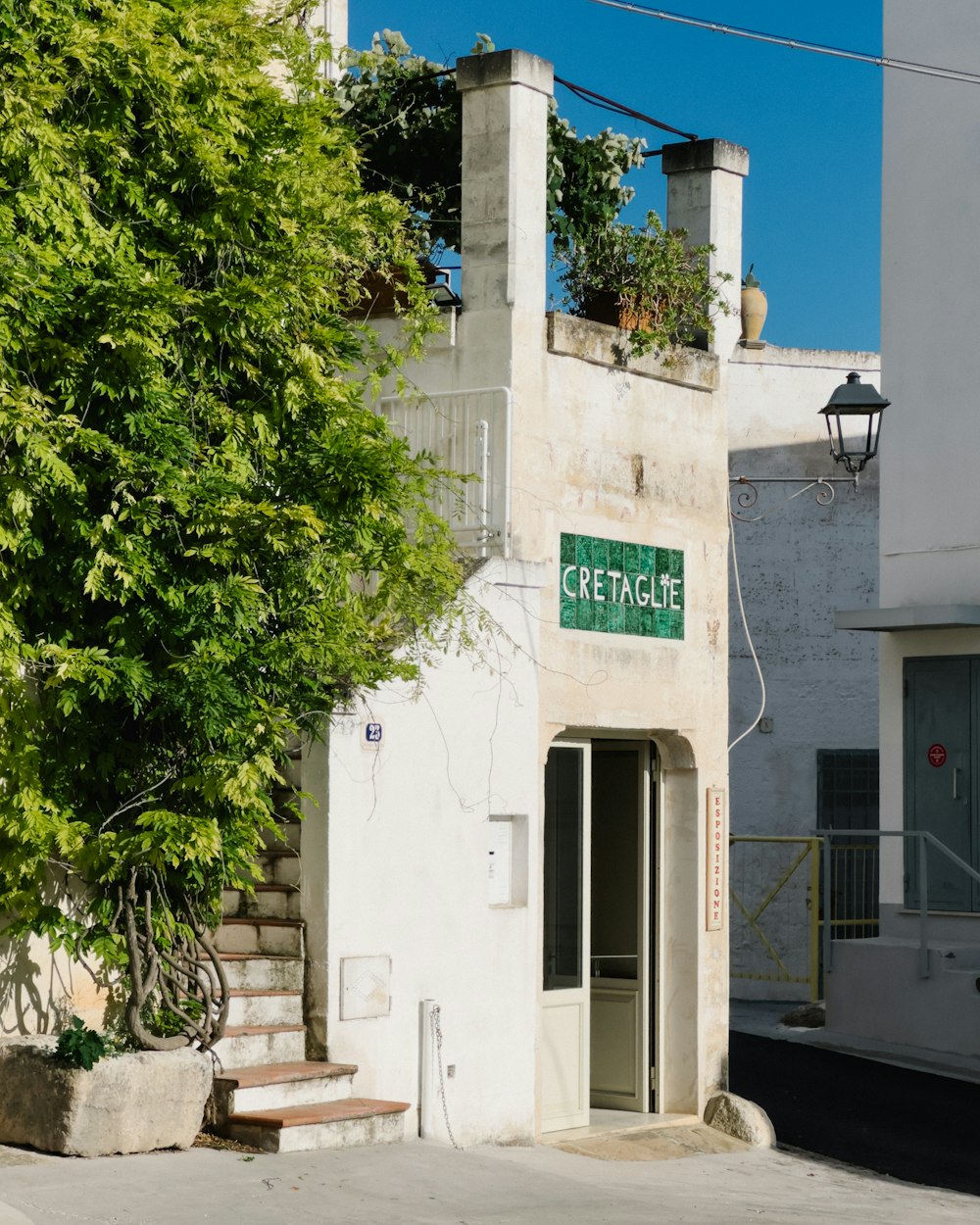 a white building with a green sign on it