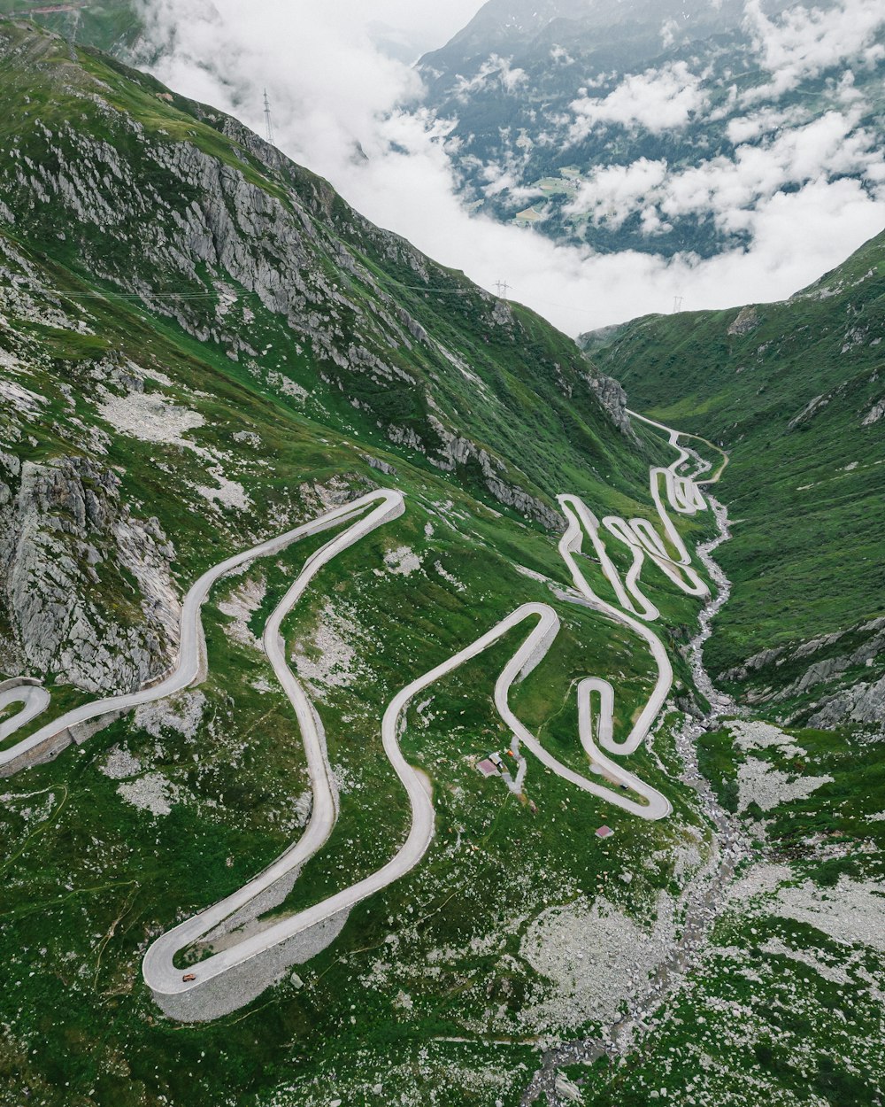 an aerial view of a winding road in the mountains