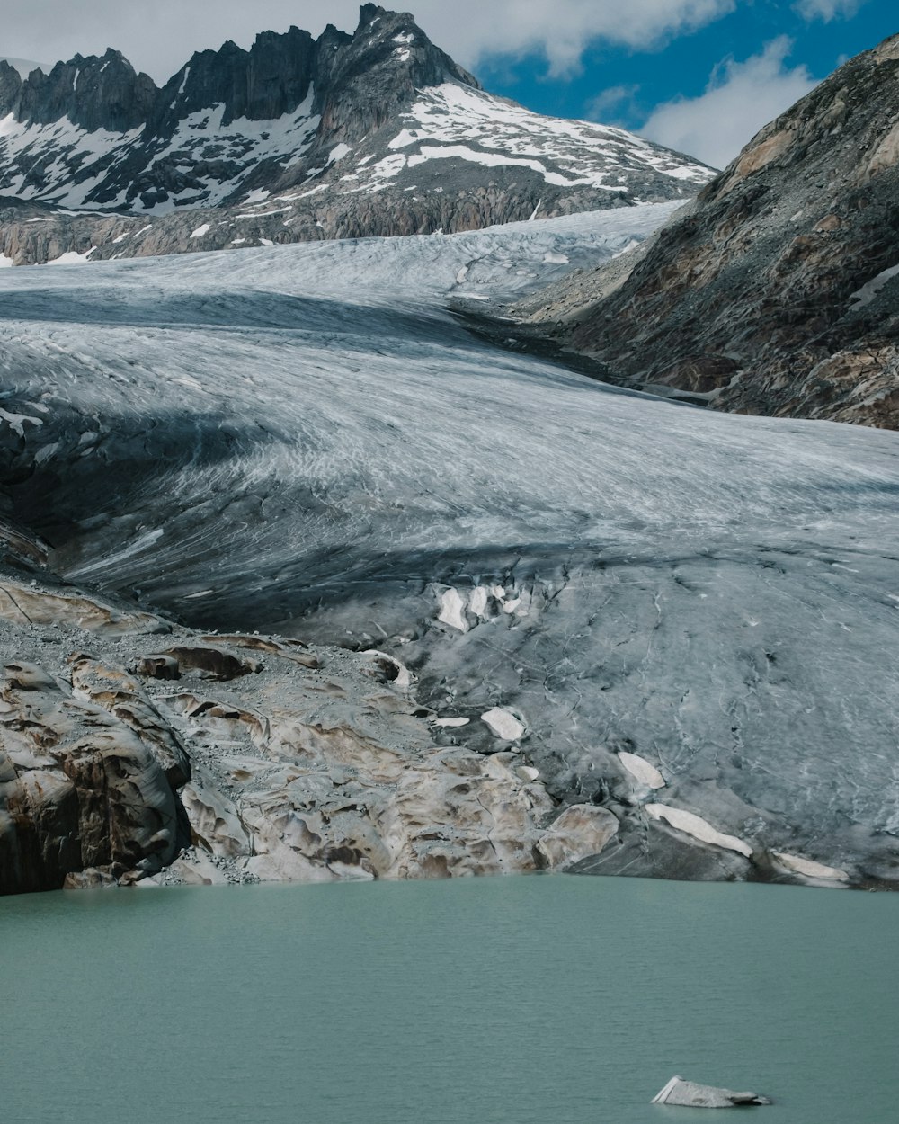 a large glacier with a mountain in the background