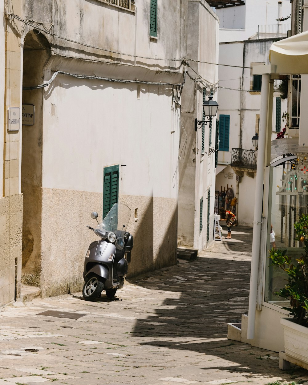 a motor scooter parked on the side of a street
