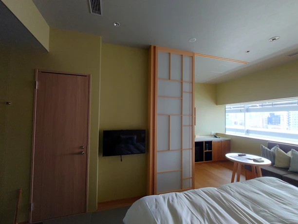 A neat, modern living room with tasteful decor and a smart lock on the door.