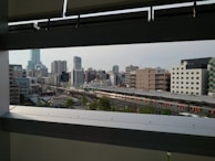 An aerial view of city skyline with train tracks below.