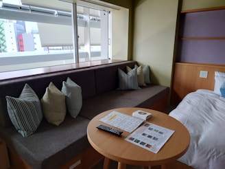 A cozy living room featuring stylish furniture and a comfortable mattress.