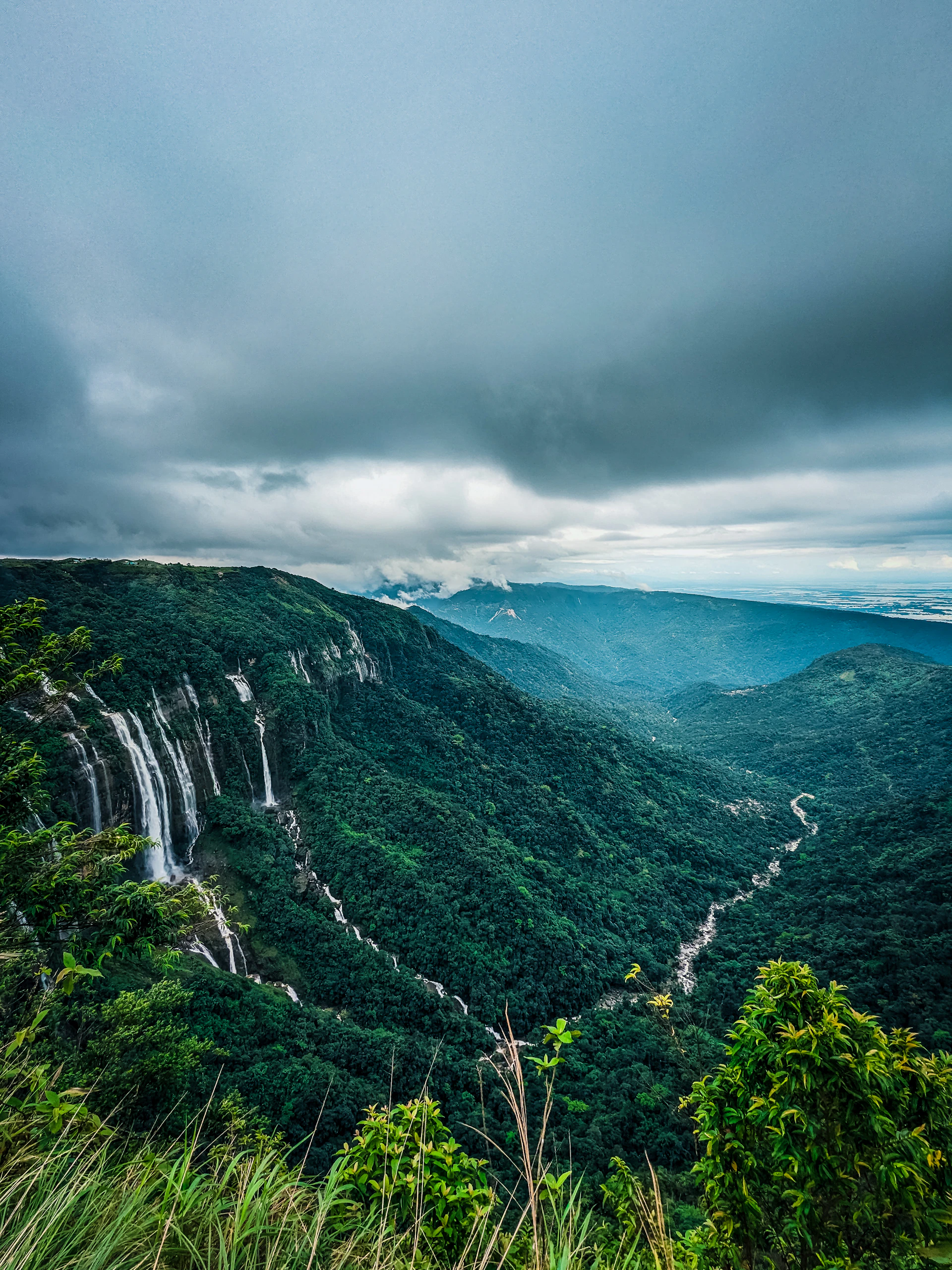 Waterfalls flowing through green Meghalaya hills