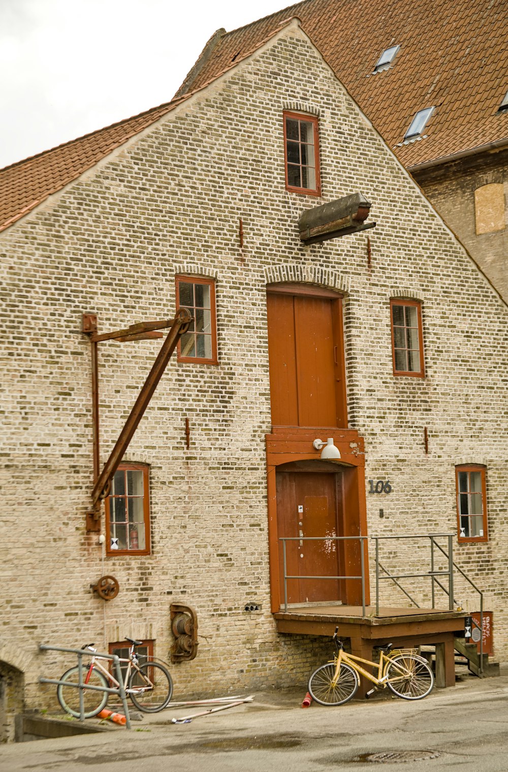 a brick building with two bicycles parked in front of it