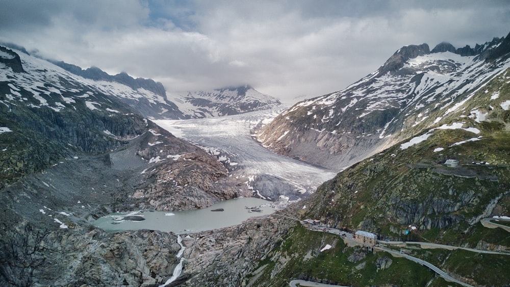 a view of a mountain range with a lake in the middle