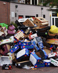 a pile of cardboard boxes sitting on top of a sidewalk