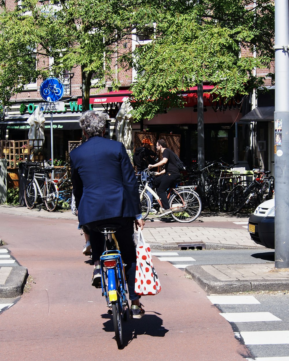 a man riding a bike down a street