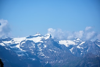 Panoramic view of mountain peaks under a clear blue sky.