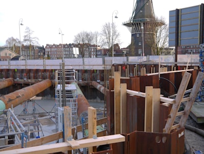 a construction site with a clock tower in the background